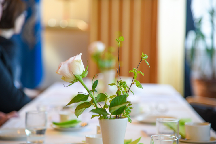 Juhlava pöytä, jossa ruusu maljakossa